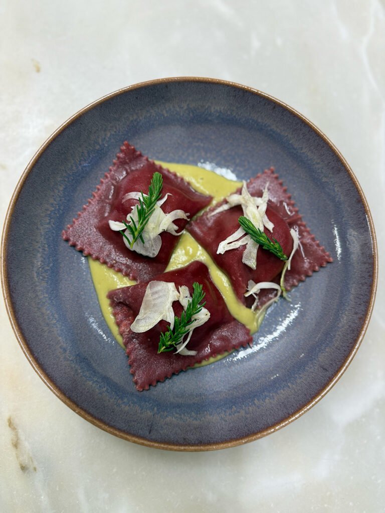 Prato de ravioli de beterraba com folhas verdes